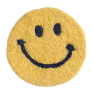 Round yellow wool felt coaster with smiley face design for heat insulation and decor