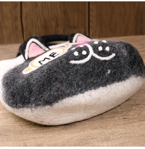 Close-up of wool felt cat handbag showing embroidery detail and soft plush texture