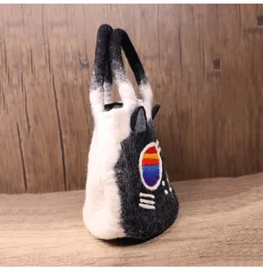 Detail of cute cat-shaped handmade wool felt tote bag with 3D ears and colorful dots