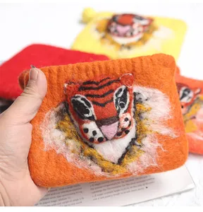 Detailed close-up of handmade 3D embroidered wool felt tiger coin purse with soft texture