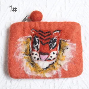 Detail of handmade wool felt orange tiger coin purse with 3D embroidery and black zipper