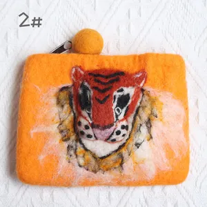Detail of handmade wool felt tiger purse featuring orange fiber and metal zipper