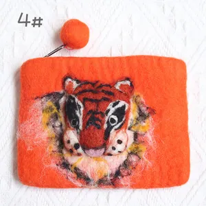 Macro detail of handmade wool felt tiger coin purse with 3D embroidery and zipper