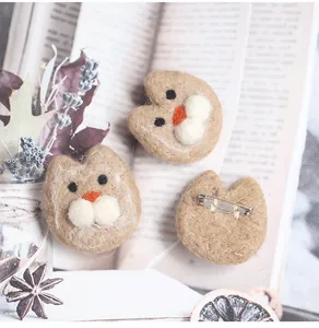 Detailed view of handmade wool felt cat brooch showing front texture and metal pin fastener