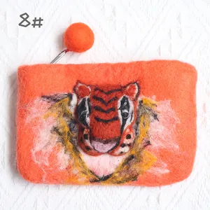 Detail of handmade wool felt coin purse featuring a 3D tiger head embroidery with zipper
