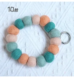 Macro detail of multicolored wool felt ball keychain 10# with silver metal keyring