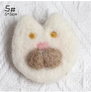 Detailed close-up of a 5x5cm handmade wool felt white cat brooch with heart nose
