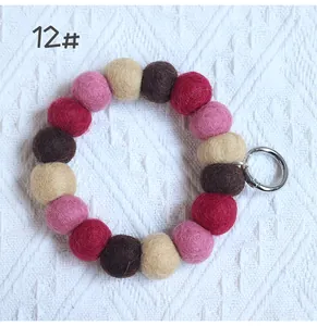 Close-up of handmade colorful wool felt balls keychain with silver metal ring