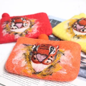 Handmade wool felt tiger coin purse with 3D animal face on a vintage magazine background