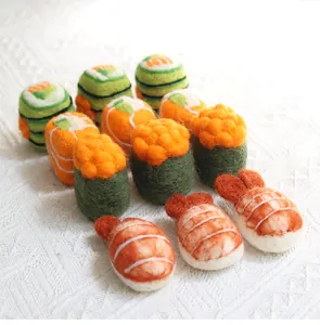 Detailed view of handmade wool felt sushi miniatures including nigiri and maki rolls