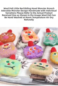 Detailed view of colorful wool felt monster brooches with red hats and fiber texture