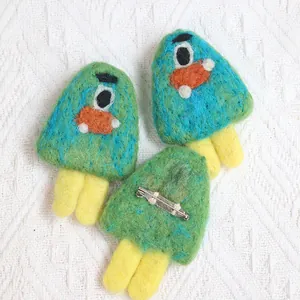 Cute handmade wool felt monster brooch set for clothing decoration showing front and back