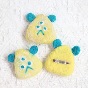 Cute three-eyed monster wool felt brooches in yellow and blue with metal pins
