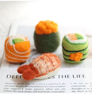 Detailed view of handmade wool felt sushi charms including salmon and sea urchin styles