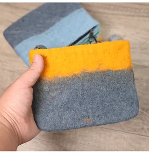 Detail of wool felt coin purse with color-block design and secure zipper closure