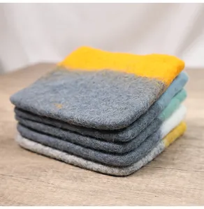 Close-up of thick felt coasters in Morandi colors with soft fibrous texture