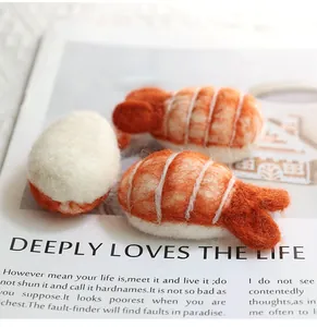 Close-up of handmade wool felt sushi charms showing detailed shrimp texture and fibers