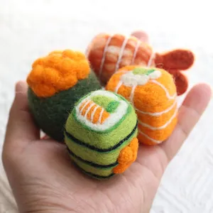 Cute handmade wool felt sushi miniatures featuring salmon and tamago nigiri pieces