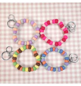 Close-up of colorful 1cm wool felt ball keychain wristlets with silver metal clasps