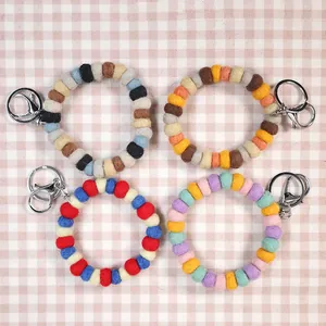 Handmade wool felt ball keychain wristlets in four color schemes for bag decoration