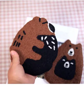 Close-up of handmade brown wool felt bear coasters with soft texture for home decor