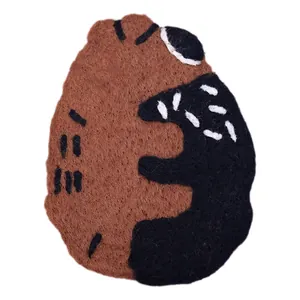 Handmade brown wool felt bear coaster with cute embroidery for cozy home table decoration