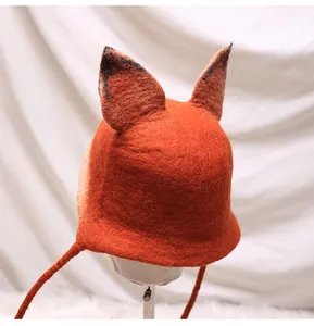 Detailed texture of handmade wool felt fox hat with cute ears and chin straps