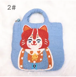 Close-up of blue felt cat tote bag with 3D needle felted kitten and blue ball charm
