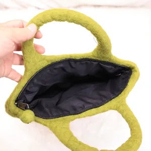 Green felt cat-shaped tote bag with black zipper and fuzzy ball charm for women