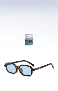 Detail of square tortoiseshell sunglasses featuring light blue lenses and rivet accents