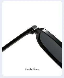 Macro detail of a durable metal hinge on black square frame glasses with size codes