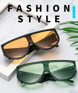 Detail of oversized retro sunglasses in orange and green lenses on marble background