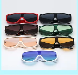 Flat lay of seven oversized shield sunglasses in various colors on white background