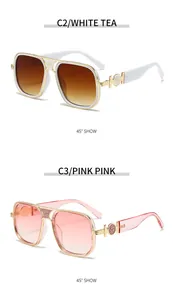 Detail view of gold metal frames with floral floral engravings and gradient lenses