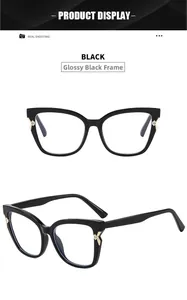Detail view of shiny black cat-eye glasses frame with golden metal X-hinge and crystal