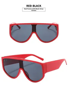 Close-up of red oversized sunglasses with grey lenses showing front and side views