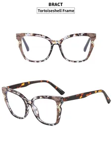 Detail view of patterned cat-eye glasses frame with marble print and gold metal accents
