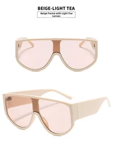 Detail view of oversized beige frame sunglasses with light tea lenses and sturdy hinges