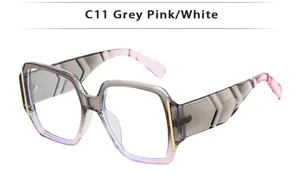 Close-up of C11 grey pink gradient sunglasses with wide temples and gold metal accents