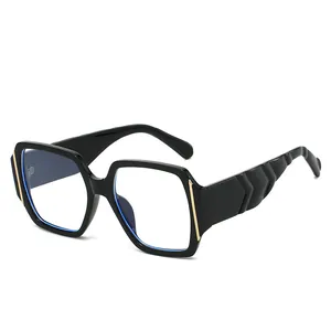 Chic black oversized square sunglasses with gold metal trim and wavy geometric temples