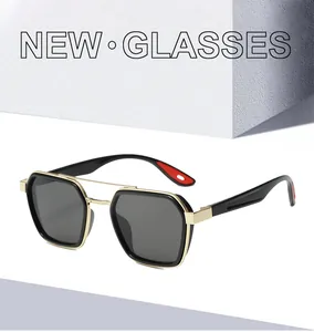 Detail of luxury sunglasses with black frames, gold double bridge and red temple accents