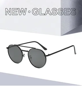 Detail view of round black metal sunglasses with double bridge and slim temples