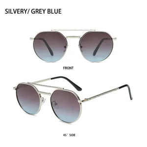 Detail view of silver metal sunglasses with intricate engraved patterns and gradient lenses