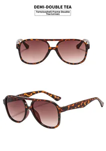 Close-up of retro pilot sunglasses with demi-patterned frame and gradient tea lenses