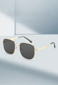 Vue détaillée des lunettes de soleil tendance en métal doré avec verres gris foncé