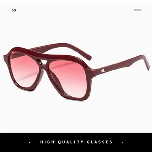 Close-up of retro burgundy aviator sunglasses with pink gradient lenses and metal rivet details