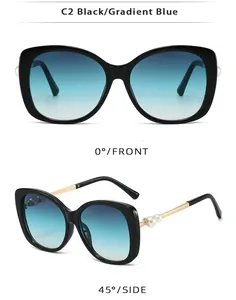 Detail view of black oversized sunglasses featuring gold metal temples and pearl accents