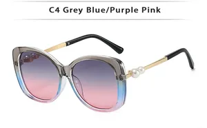 Detail of C4 sunglasses showing gradient lenses and pearl-embellished gold metal temples
