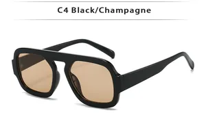 Détail de lunettes de soleil aviateur carrées noires C4 avec verres champagne chic