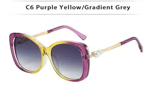 Detail of gradient purple yellow frame sunglasses with pearl accents on metal temples